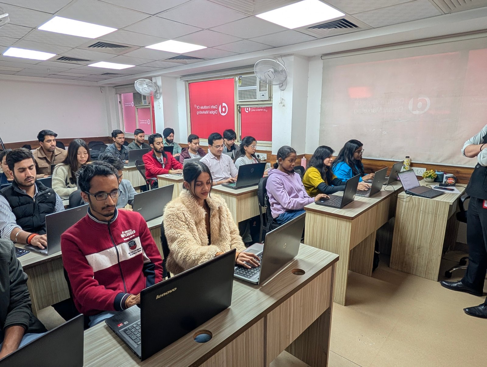 Students learning digital marketing on laptops